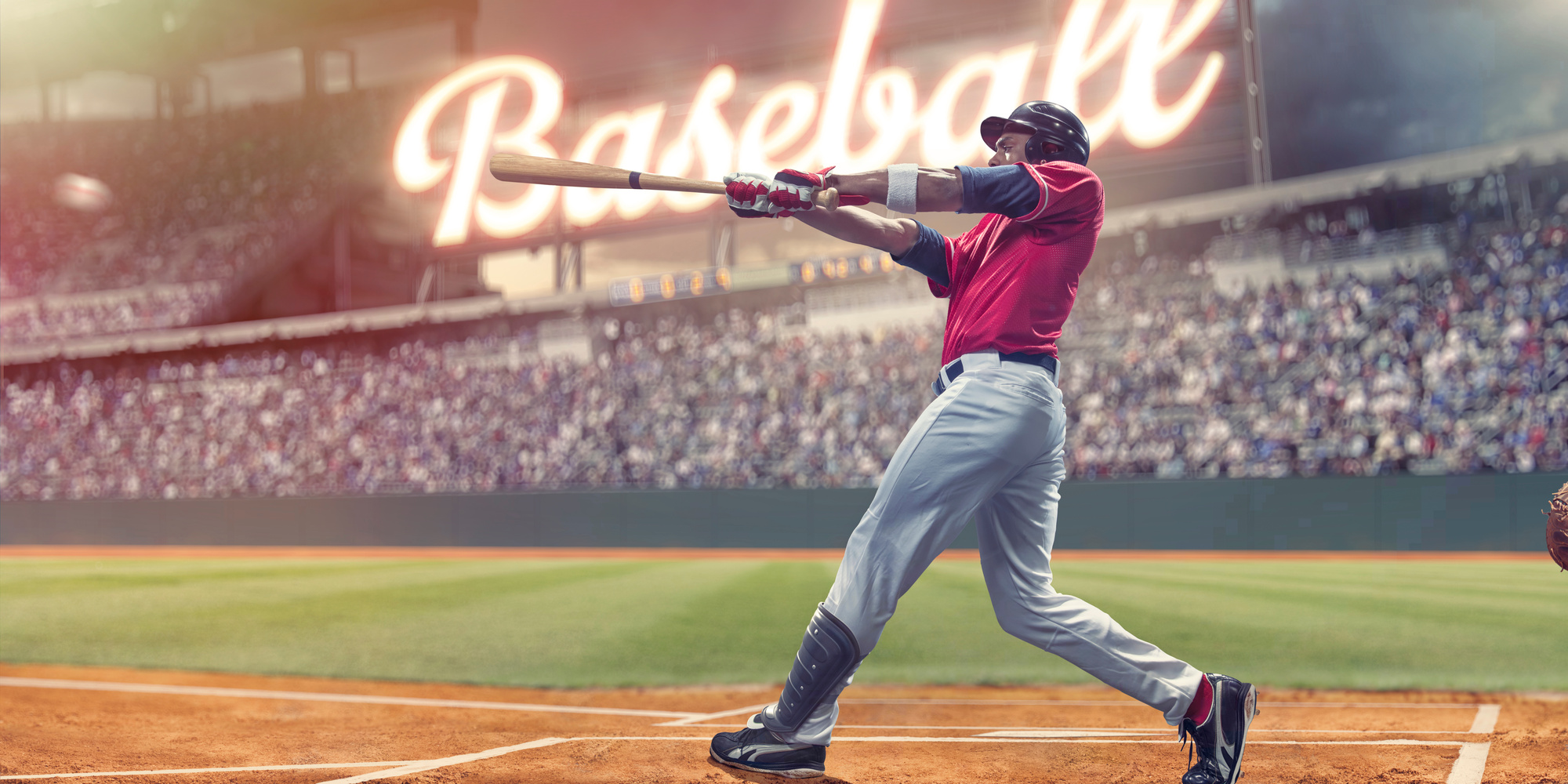 Professional Baseball Batter Striking Baseball During Night Game In Stadium